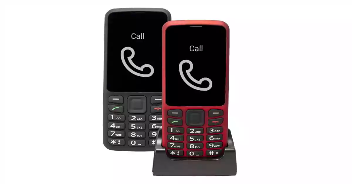 Dois telefones, um preto outro vermelho, teclado preto e ecrã de alto contraste